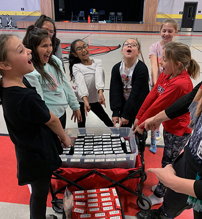 young dancers standing about a container